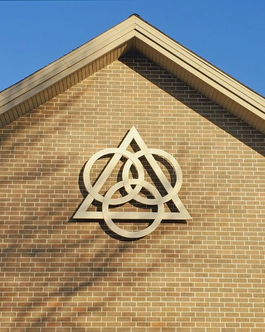 A symbol of the Trinity on the outside of a church building